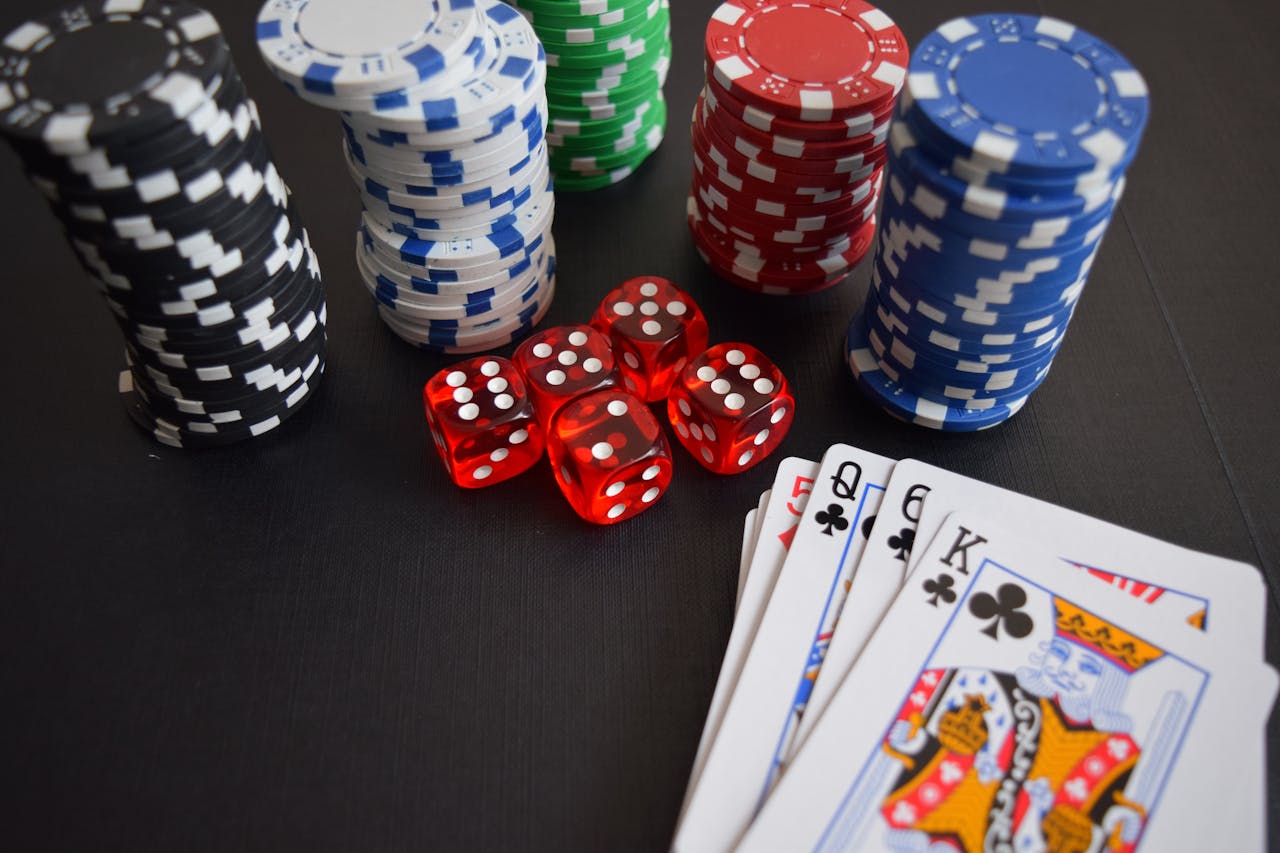 Dubibet Gambling Access Page | Login & Start Casino Games A vibrant display of casino chips, dice, and playing cards set on a table, embodying chance and excitement.