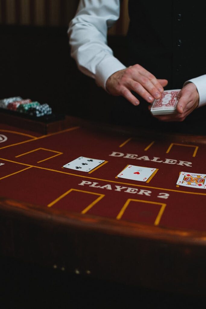 Dubibet Register & Login | Online Casino Entry for New Users Close-up of a casino dealer dealing cards on a gaming table during a gambling session.