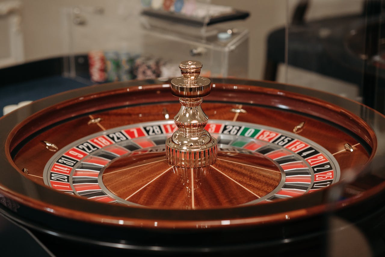 Dubibet Gambling Login | Fast Access to Online Casino Games. Close-up of a classic roulette wheel in a casino setting showcasing the elegant wooden design.