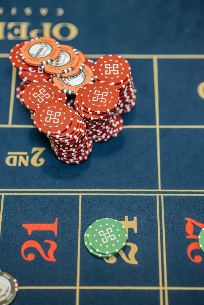 Dubibet Gambling Portal | Official Entry & Secure Login Close-up view of poker chips stacked on a casino gaming table, ready for betting.